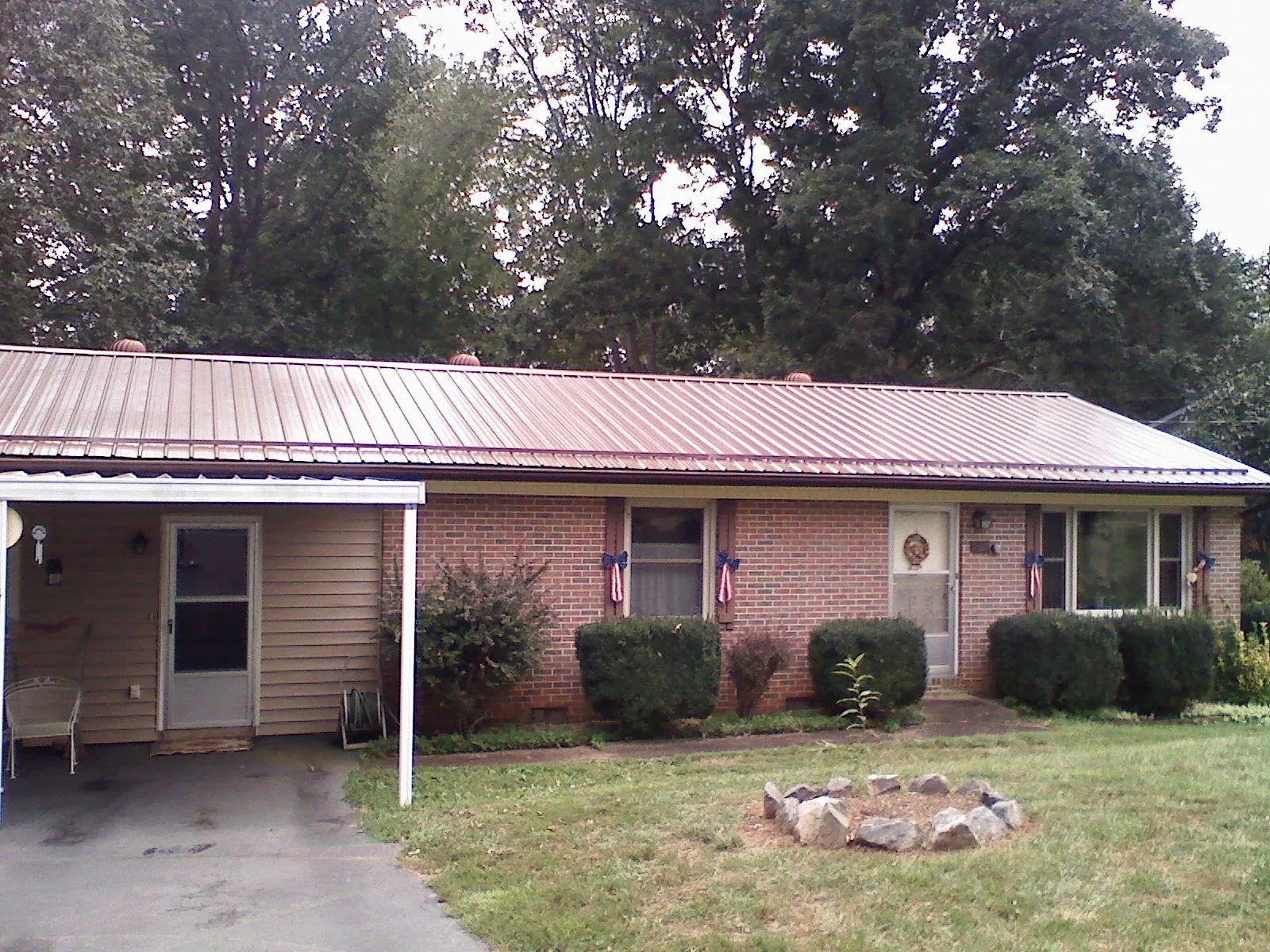 Bronze metal roof and carport on a brick ranch home — Roof Repair work by our crew in Bon Air